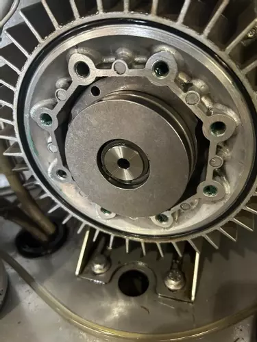 Close-up of new wobble disc installed inside pump assembly during servicing of a Nilfisk SH Truck Booster, ensuring smooth and reliable pump operation.